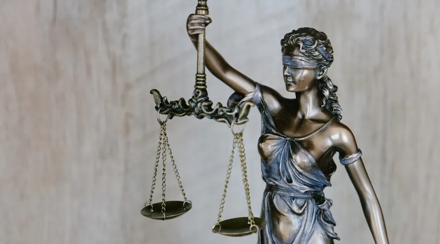 Legal documents and a gavel on a wooden desk