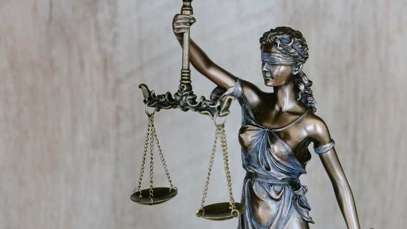 Legal documents and a gavel on a wooden desk