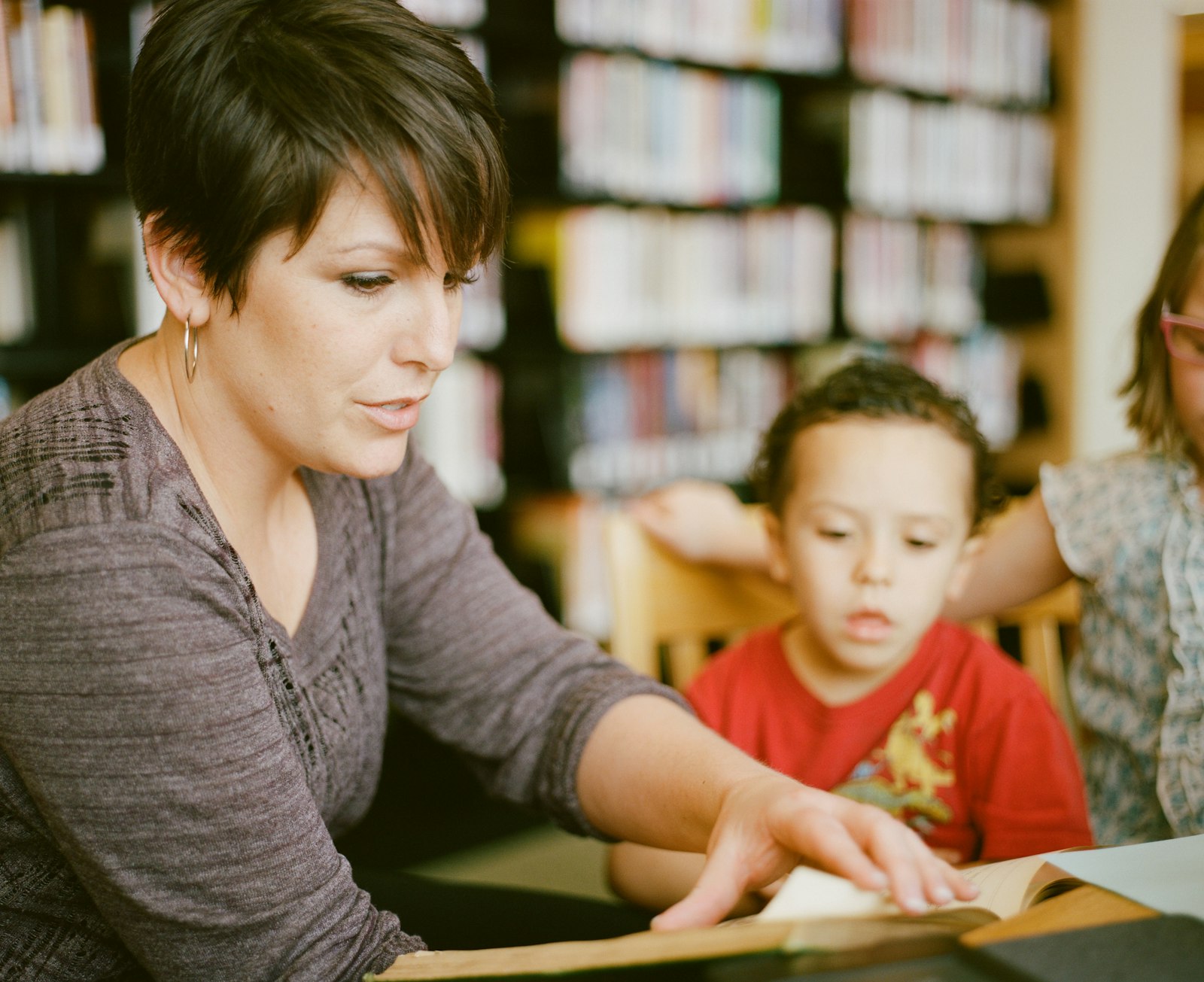 Teacher sitting beside a student and providing one-on-one support